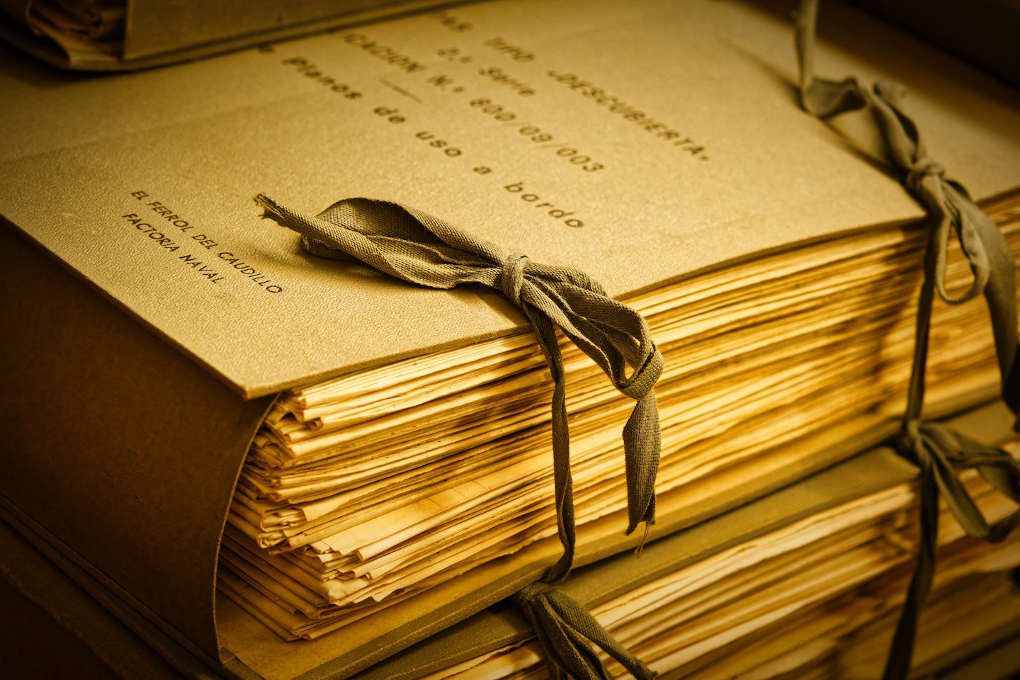 Aged Spanish documents tied with ribbon.