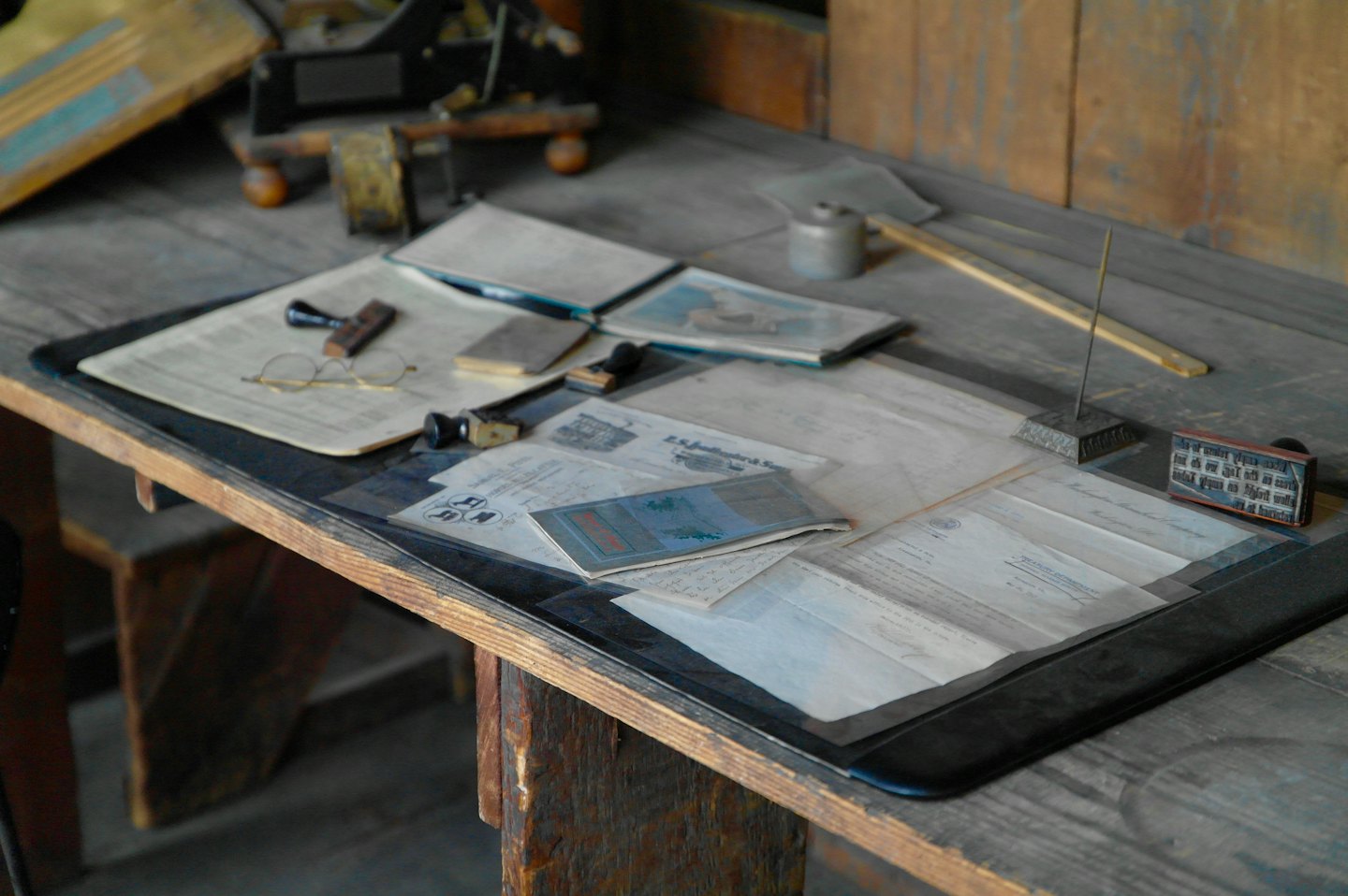 Antique wooden desk with vintage office supplies and papers.